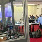 Interpreters at work in their soundproof booths interpreting for delegates at a European Works Council meeting
