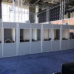Multiple soundproof interpreter booths set up backstage at Xerox event in Portugal