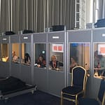 Interpreter booths set up at conference. Interpreters working inside them