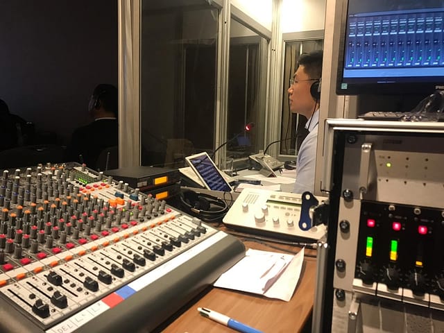 Interpreter working in booth our Brahler Interpretation equipment