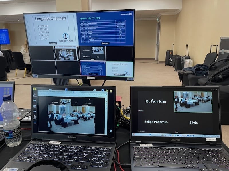 laptops and switcher set up on desk for hybrid interpretation